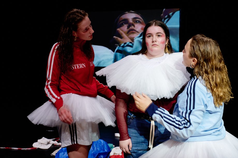 Actresses apply make-up to another person.