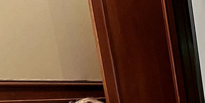 A young man shows an older woman something on a tablet