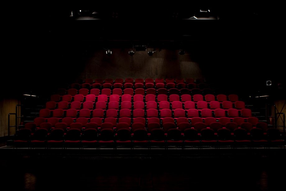 View of red, empty theater seats in a theater hall