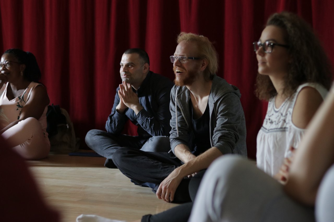 Four participants listen and watch.