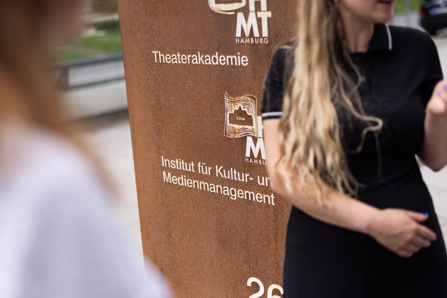 A student next to the entrance portal to the KMM