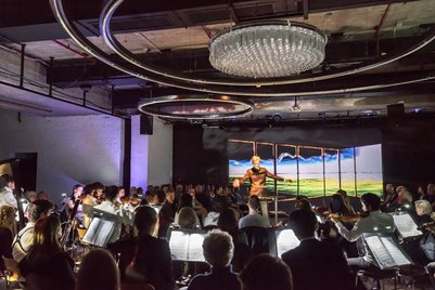 Orchestra with conductor and audience