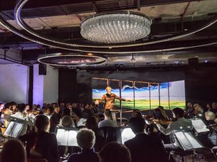 Orchestra with conductor and audience